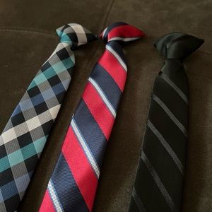 Boys clip on ties. Worn once, excellent condition. Three styles (15” long)